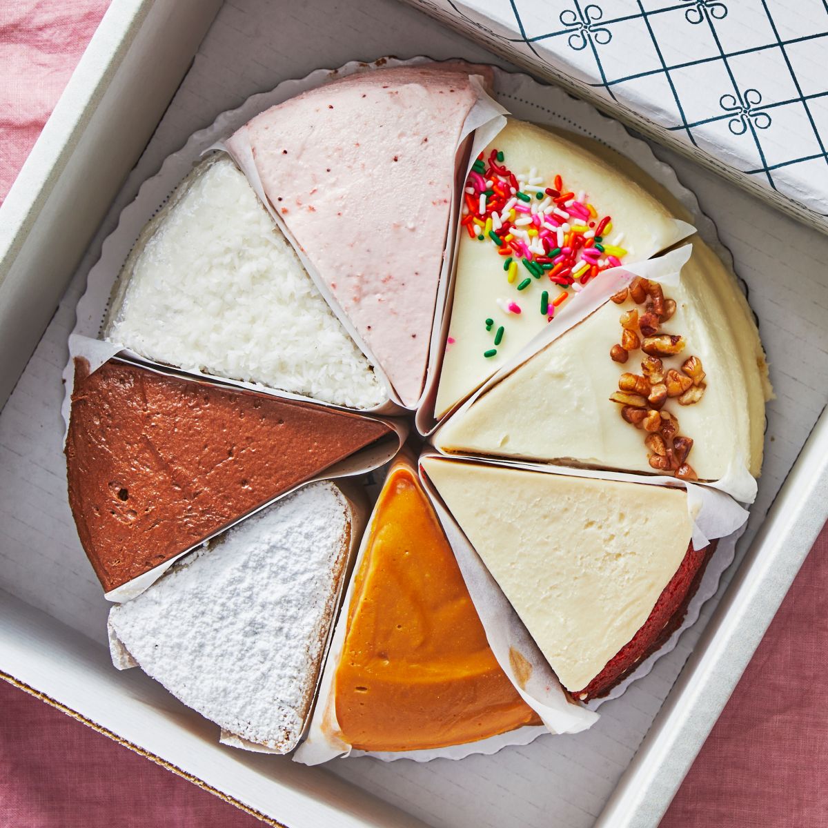 Assorted Sugaree’s Sampler Cake slices in a box with different flavors and toppings