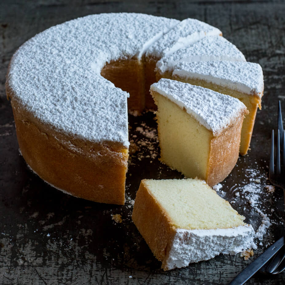 Sliced cream cheese pound cake with powdered sugar on top