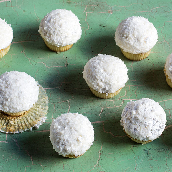 Coconut cupcakes on a green countertop