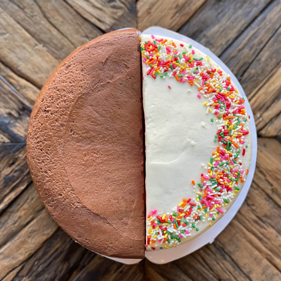 Half chocolate and half vanilla cake on a wooden table top
