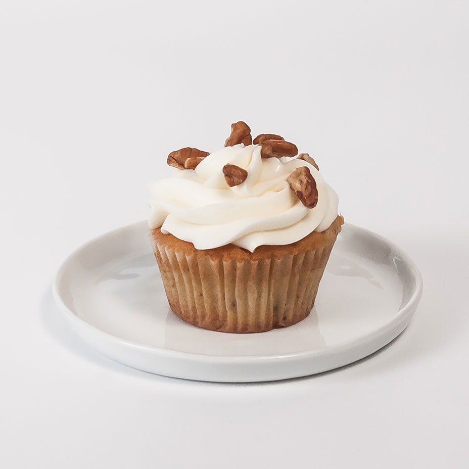 Italian cream cupcake on a white plate