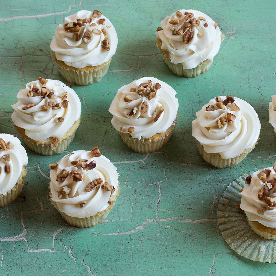 Italian cream cupcakes on a green countertop