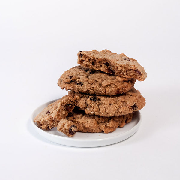 Stacked oatmeal raisin cookies on a white plate