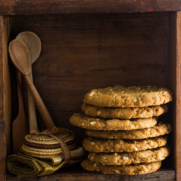 Peanut butter cookies stacked on a wooden shelf