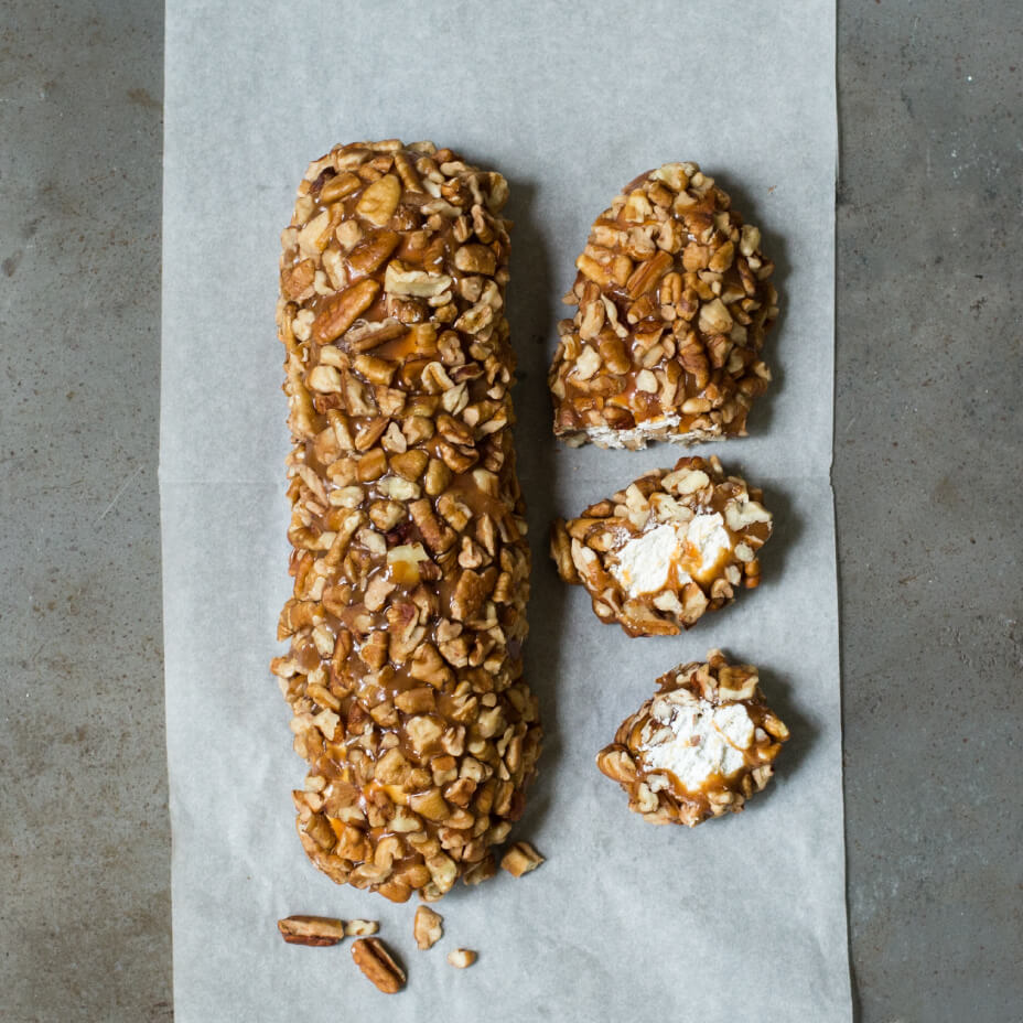 Sliced pecan log on a concrete countertop