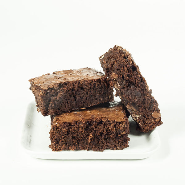 Plain brownies squares on a white plate