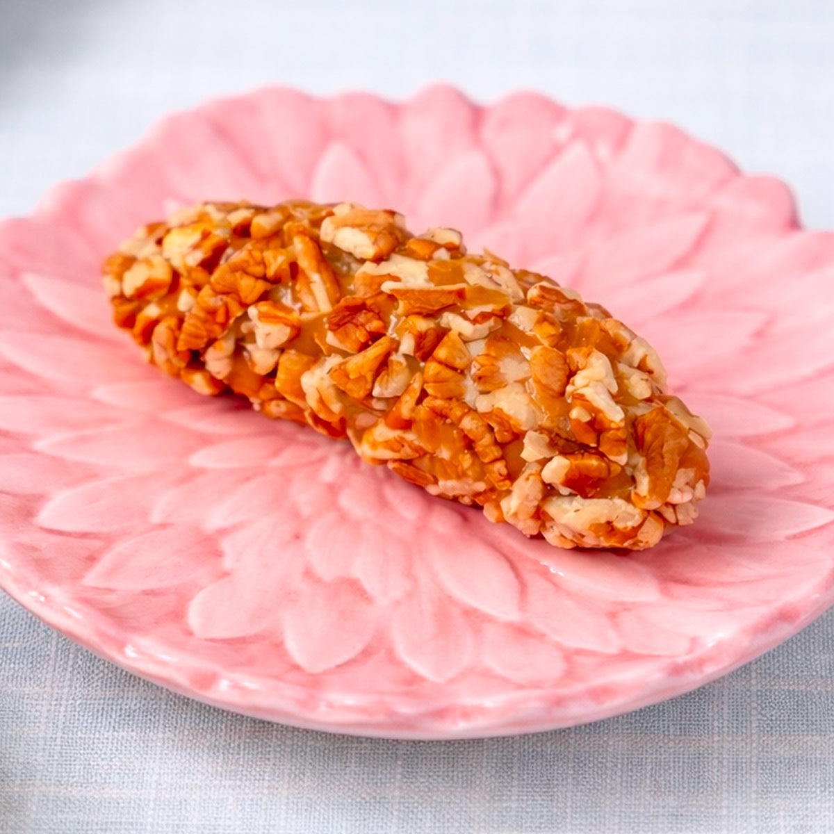 A mini Sugaree’s Pecan Log on a pink floral plate