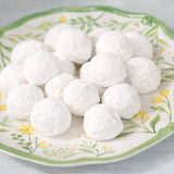 Sugaree’s Wedding Cookies dusted with powdered sugar on a floral-patterned plate