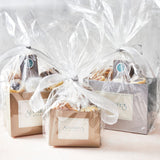 Three gift boxes with cellophane wrapping and Sugaree’s bakery branding on a light background