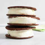 Stack of three Sugaree’s Vanilla Ice Cream Sandwiches with chocolate cookies and on a white background