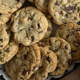 A close-up top-down view of a Sugaree’s Dessert Tray piled high with chocolate chip cookies