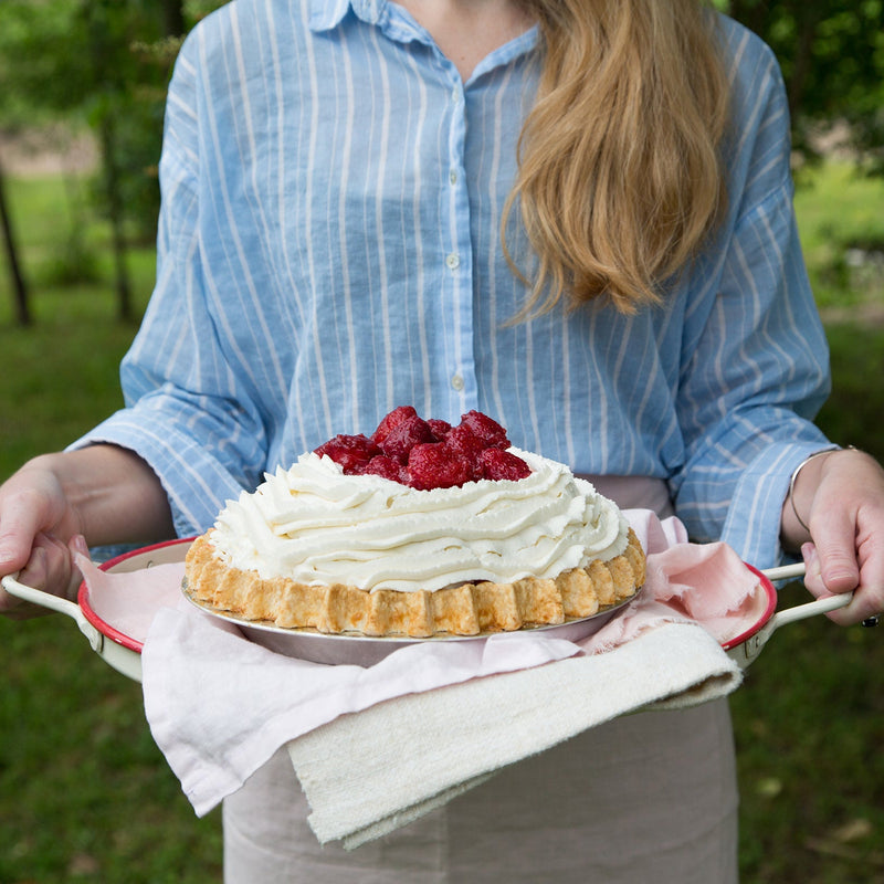 Strawberry pie outdoors on vintage platter with pink linens