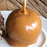 Caramel apple on a white paper plate