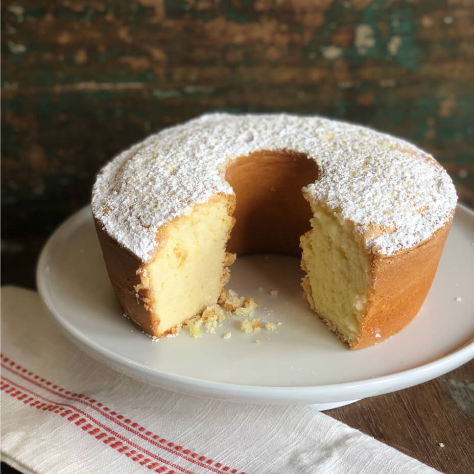 Cream cheese pound cake on a white tray on a wooden table