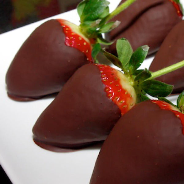 Chocolate covered strawberries on a white plate