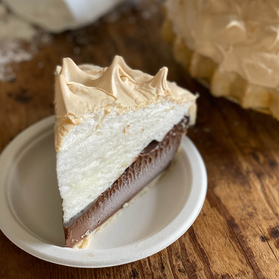 Close up on a slice of chocolate meringue pie