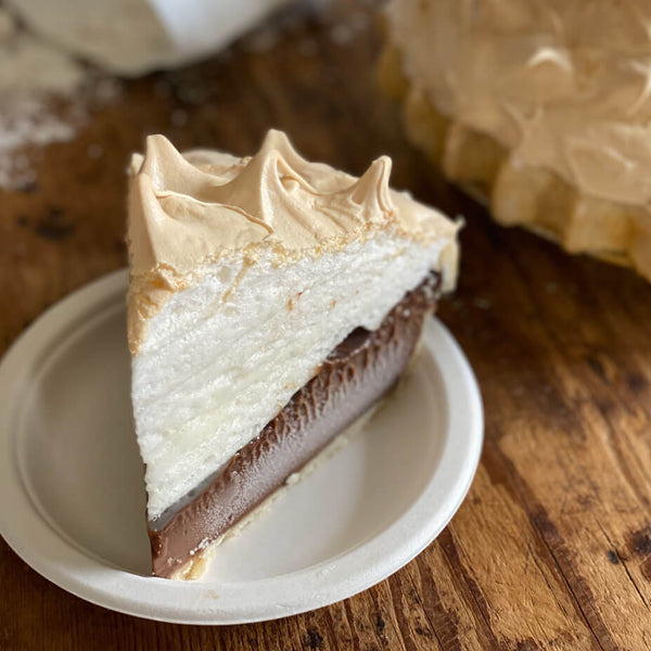 Close up on a slice of chocolate meringue pie