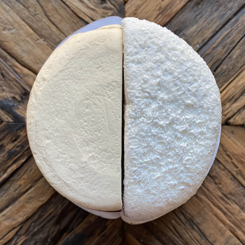 Two cake halves on wooden table top