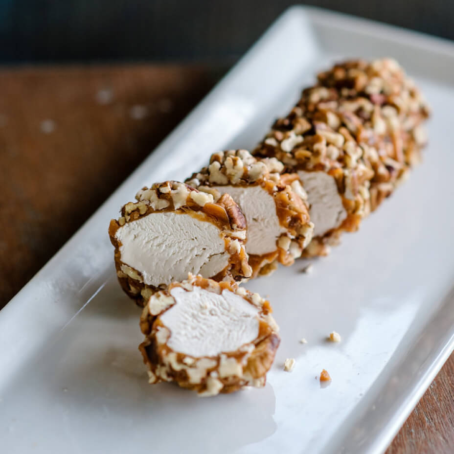 Sliced pecan log on a white tray