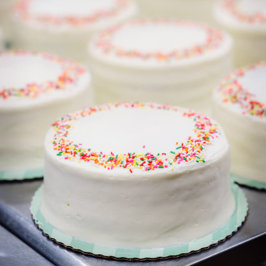Rainbow cakes on blue cardboard trays