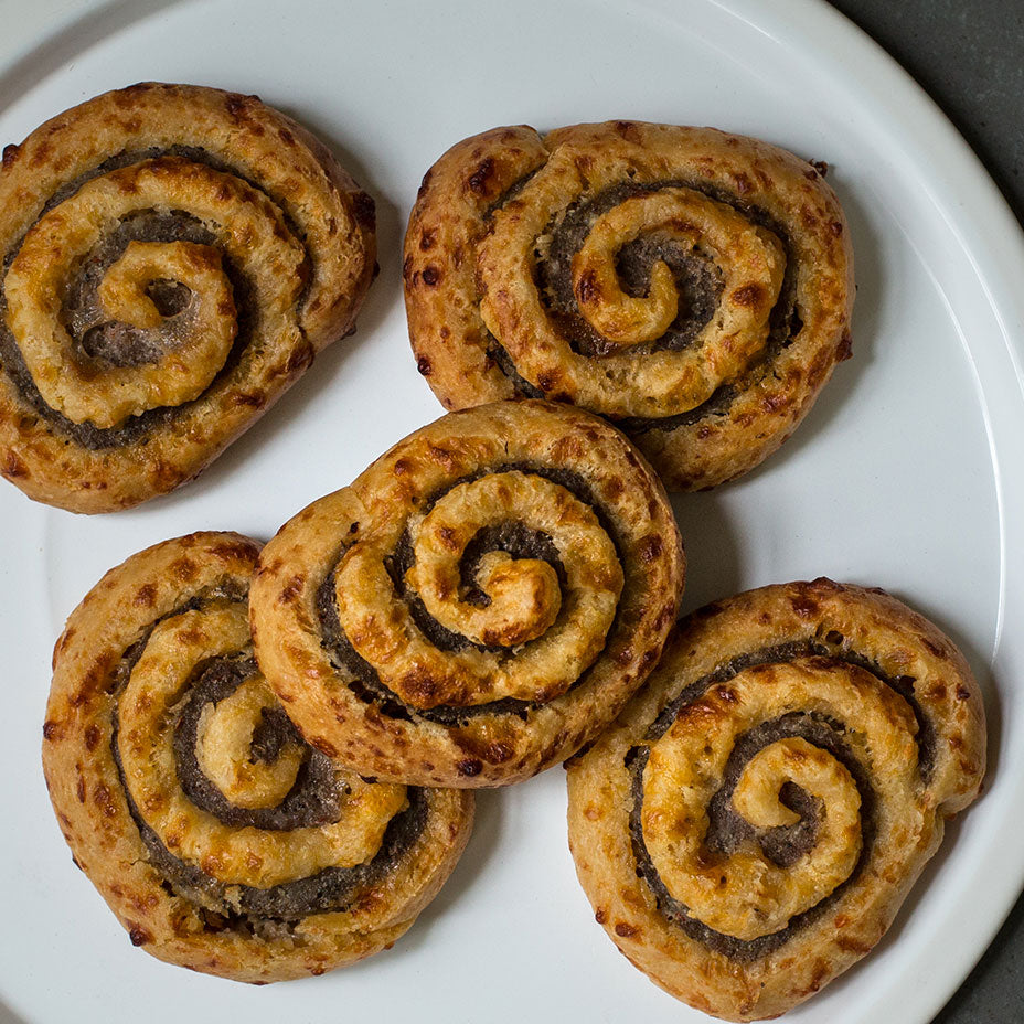 Five Sugaree’s Sausage Pinwheels on a white plate