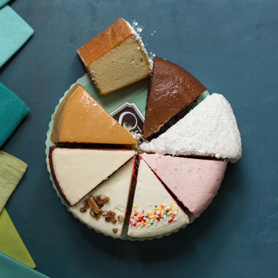 Chocolate, rainbow, Italian cream, strawberry, red velvet, cream cheese pound cake and Southern caramel cake slices on a teal plate