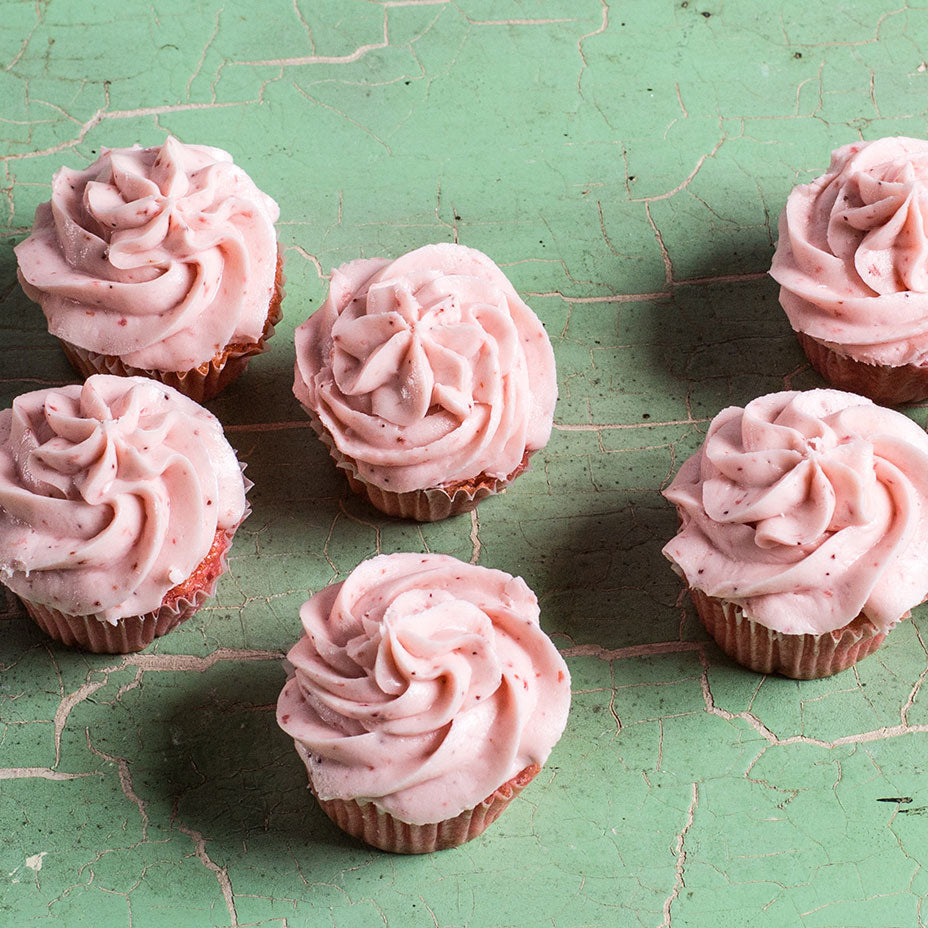 Strawberry cupcakes on a green countertop