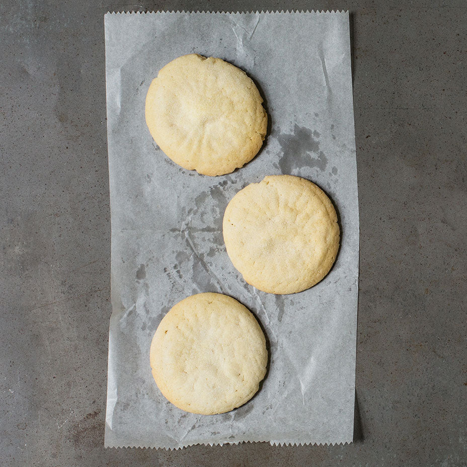 Three tea cakes on a concrete countertop