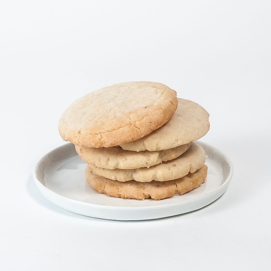 Stacked tea cakes on a white plate